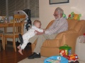 Bradley takes a ride on Grandpa's leg.