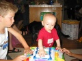 Kyle shows Bradley how to use his new learning table.
